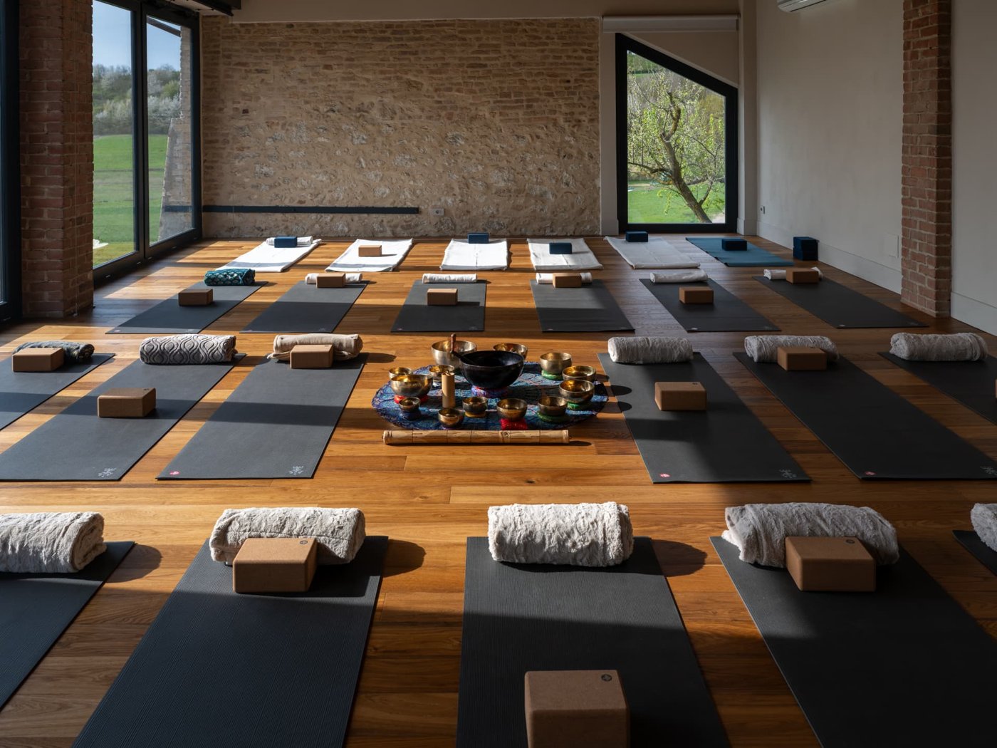 The yoga shala at Retreat Monferrato, set with mats and singing bowls